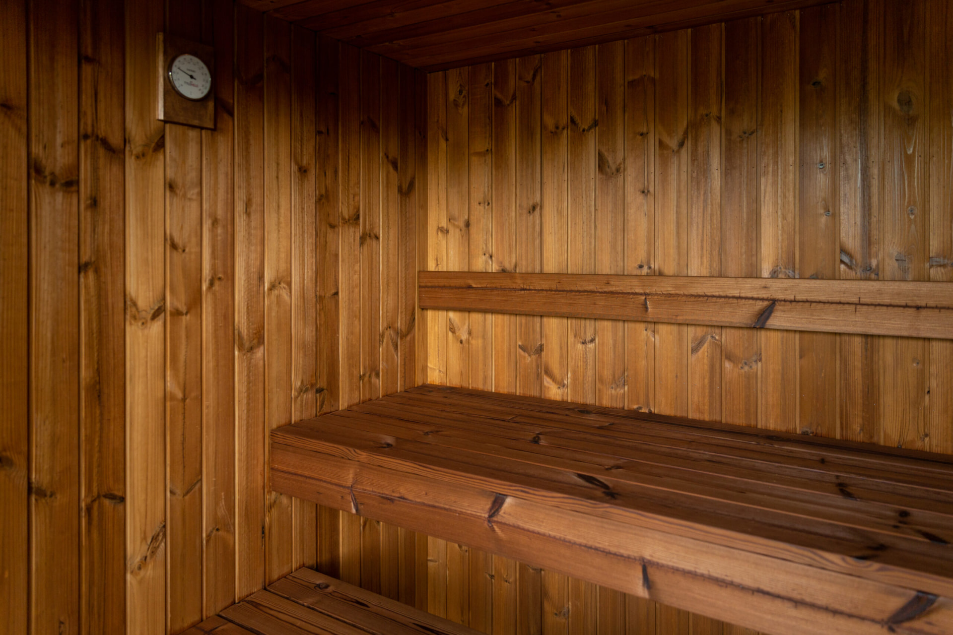 Thermo-treated timber sauna bench and cladding detail