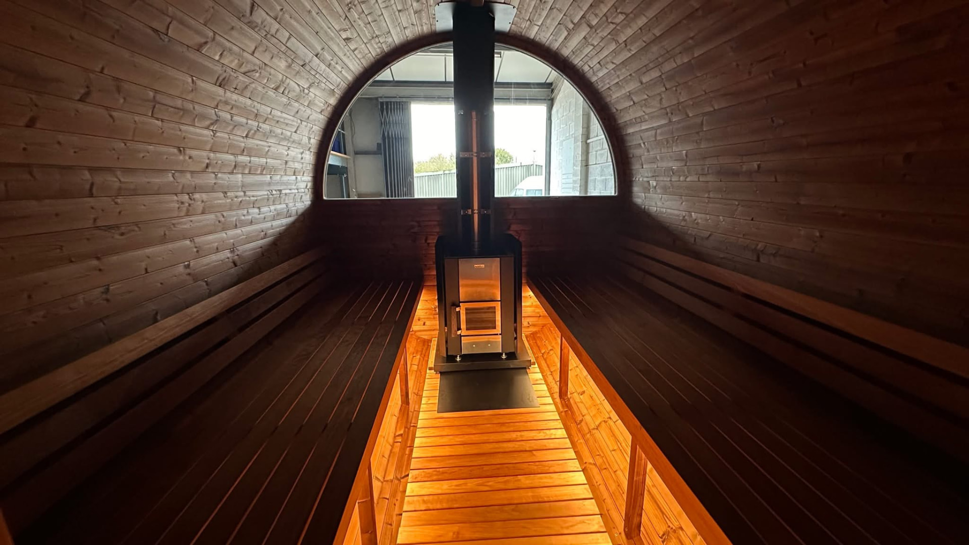 Barrel sauna interior with wood-fired stove